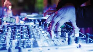 DJ Console Hands Is Mixing A Music Track For The Disco With Strobe Lights video