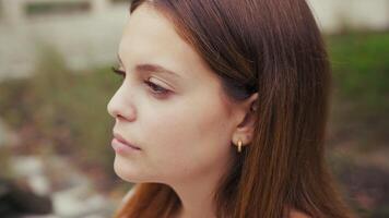 Girl With Neutral Facial Expression Looks Forward In Nature video