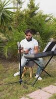 Man Musician Prepares The Keyboard To Play At A Birthday In Garden video