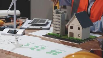 A man is working on a model of a house video