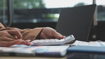 A person using a calculator on a desk video