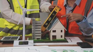 Two people working on a model of a house video