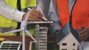 Two people working on a model of a house video