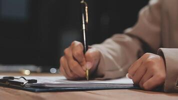 A person is writing on a piece of paper with a pen video