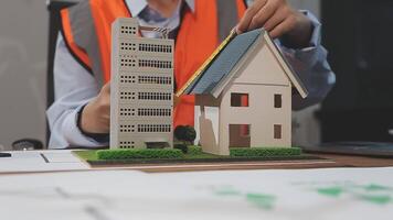 A man is working on a model of a house video