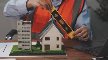 A man is working on a model of a house video