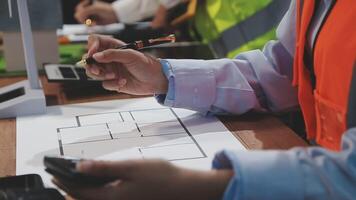 A person in a safety vest is working on a blueprint video