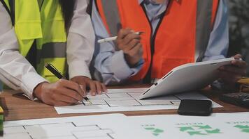 Two people working on a project with a tablet video