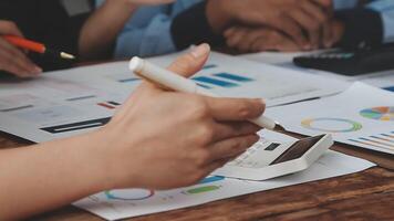 Business people working on a table with papers and pens video