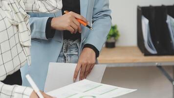 Two business people are holding papers and one is pointing to something video