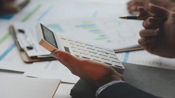 Businessman using calculator to calculate the cost of a project video