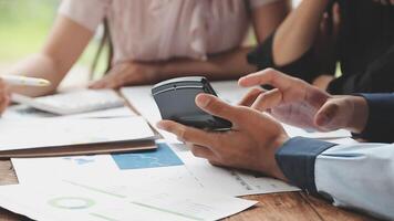 Business people using a cell phone at a table video