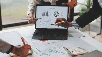 Business people working on a laptop with graphs and papers video