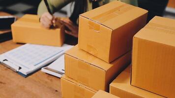 A person is sitting at a desk with a stack of boxes video