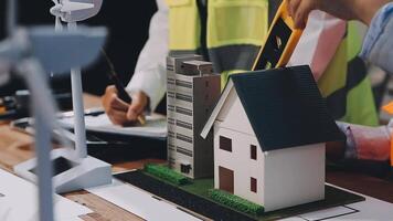 A man is working on a model of a house video