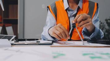 A man in an orange vest is working on a project video