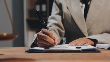 A person in a suit writing on a piece of paper video