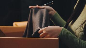 A woman is holding a piece of fabric in a box video