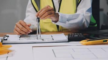 A person in a safety vest is working on a blueprint video