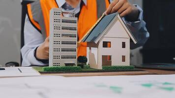 A man is working on a model of a house video