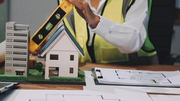 A woman is holding a model of a house on a desk video