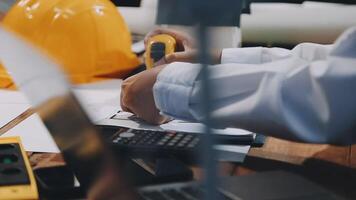 A person in a hard hat is working on a project video