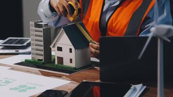 A man is working on a model of a house video