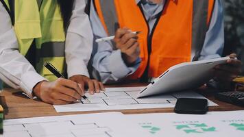 Two people working on a project at a table video