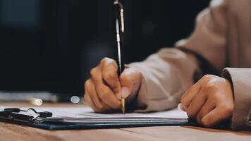 A person is writing on a piece of paper with a pen video