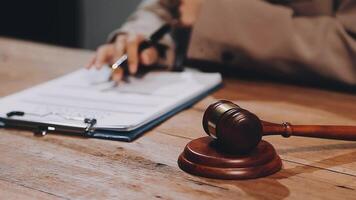 A judge's gavel on a desk with a pen and paper video