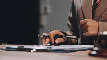 A person in a suit holding a pen and writing on a piece of paper video