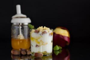 Diet yogurt for breakfast. sweet homemade yogurt in a glass with apples, nuts and honey photo