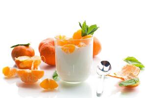 Creamy yogurt with tangerine slices, isolated on white background photo