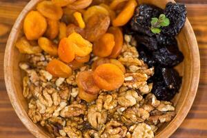 Natural dried Prunes, dried apricots and nuts close-up in macro photography photo