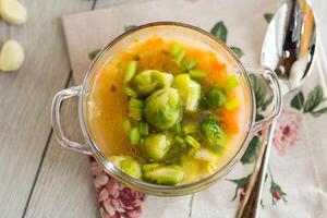 View from above. Hot Broth with Brussels Sprouts and Vegetables photo