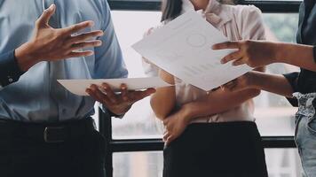 Three business people talking about something on a paper video
