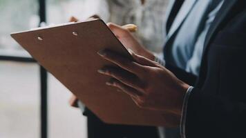 A person in a business suit holding a clipboard video