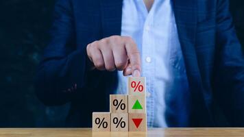 Financial, stocks, interest rate and GDP percent change, wooden block with percentage sign and arrow up sign and down for interest rate, ranking, Financial. gdp photo