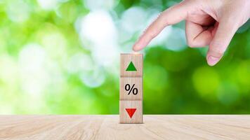 Financial, stocks, interest rate and GDP percent change, wooden block with percentage sign and arrow up sign and down for interest rate, ranking, photo