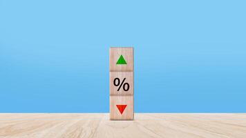 Financial, stocks, interest rate and GDP percent change, wooden block with percentage sign and arrow up sign and down for interest rate, ranking, percentage sig photo