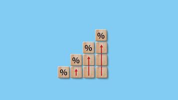 Financial, stocks, interest rate and GDP percent change, wooden block with percentage sign and red arrow up sign for interest rate, ranking photo