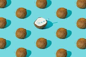Fruit pattern made of coconuts on light pastel blue background. Minimal tropical beach concept. Nature summer composition. Trendy summertime party idea. Coconut aesthetic. Creative food backdrop. photo