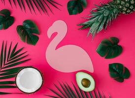 Creative layout with pineapple, coconut, avocado and tropical leaves with pink flamingo paper card note copy space on pink background. Summer tropical fruits and leaves idea. Food concept. Flat lay. photo