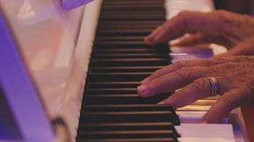 A close up of a person's hands playing the piano video
