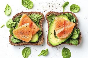 Two slices of whole grain toast with smoked salmon and avocado photo