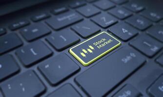 Stock market concept on a highlighted keyboard key. Business and finance photo
