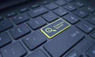 Financial search concept on a highlighted keyboard key. Business and finance photo