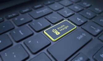 Profit margin concept on a highlighted keyboard key. Business and finance photo