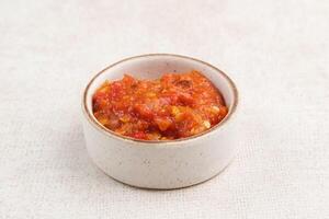 Sambel or Sambal Tomat, made from tomatoes, chilies, salt, sugar, garlic, shallots and shrimp paste. Indonesian food. photo