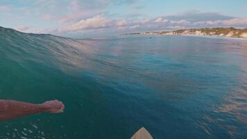 Professional surfer rides on fast ocean wave in Bali, first person view video
